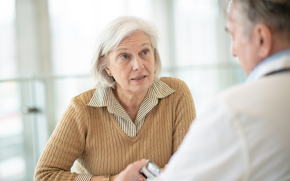 Elderly woman speaking to doctor