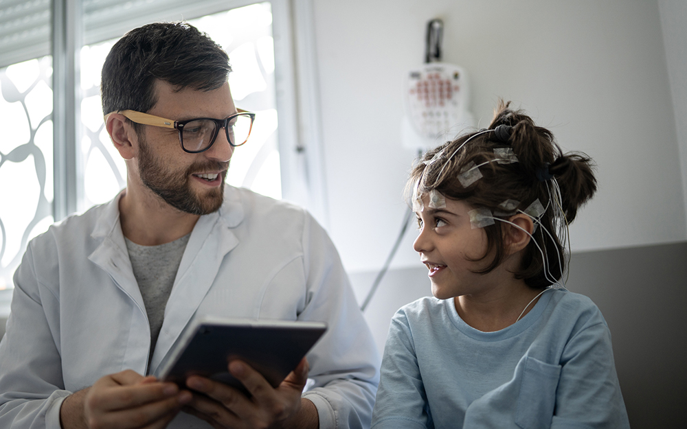 Child getting an EEG with doctor