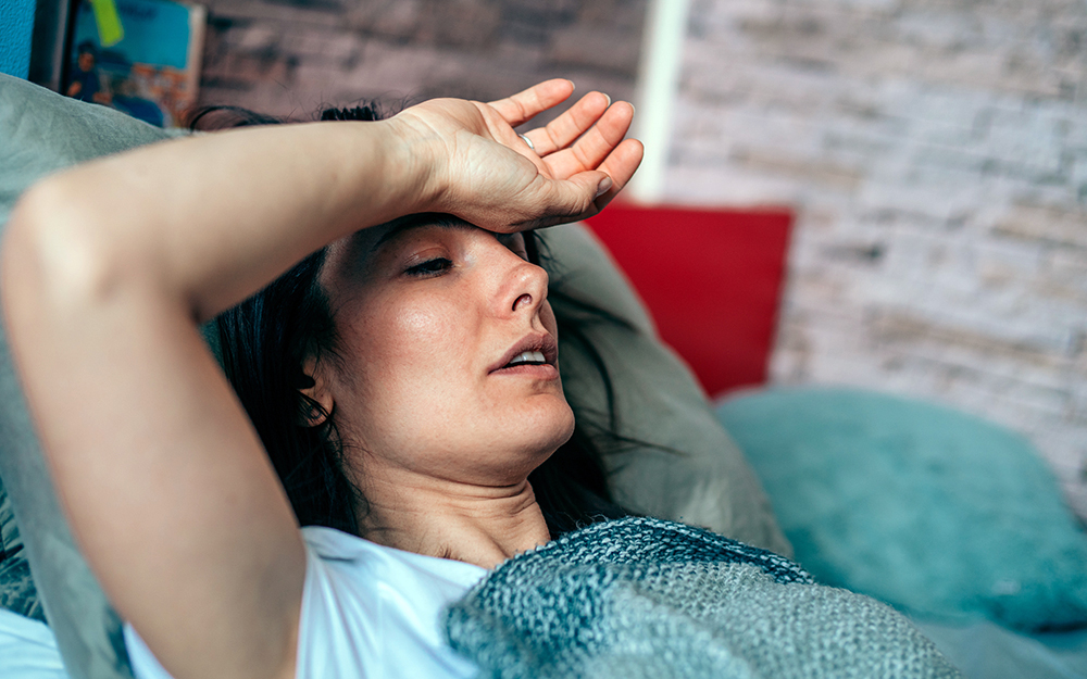 Tired woman lying on couch