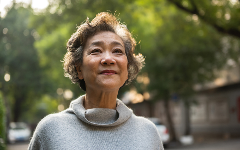 An older asian woman undergoing hormone replacement therapy to relieve menopausal symptoms.