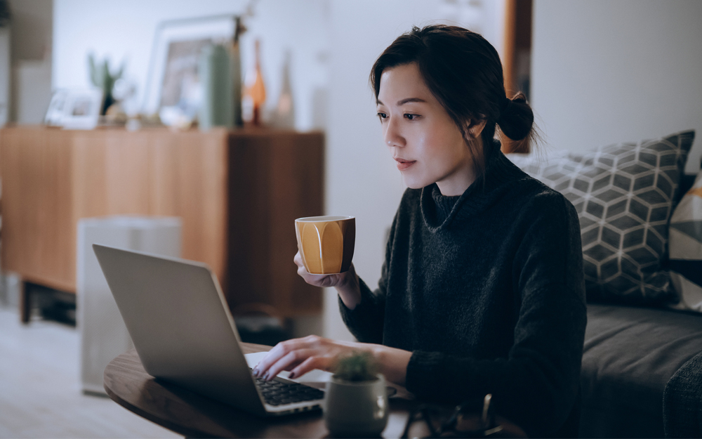 An Asian woman looking at the results from a virtual second opinion with Cedars-Sinai.