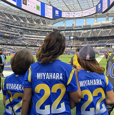 The Miyahara family in Rams jerseys at a Los Angeles Rams game.