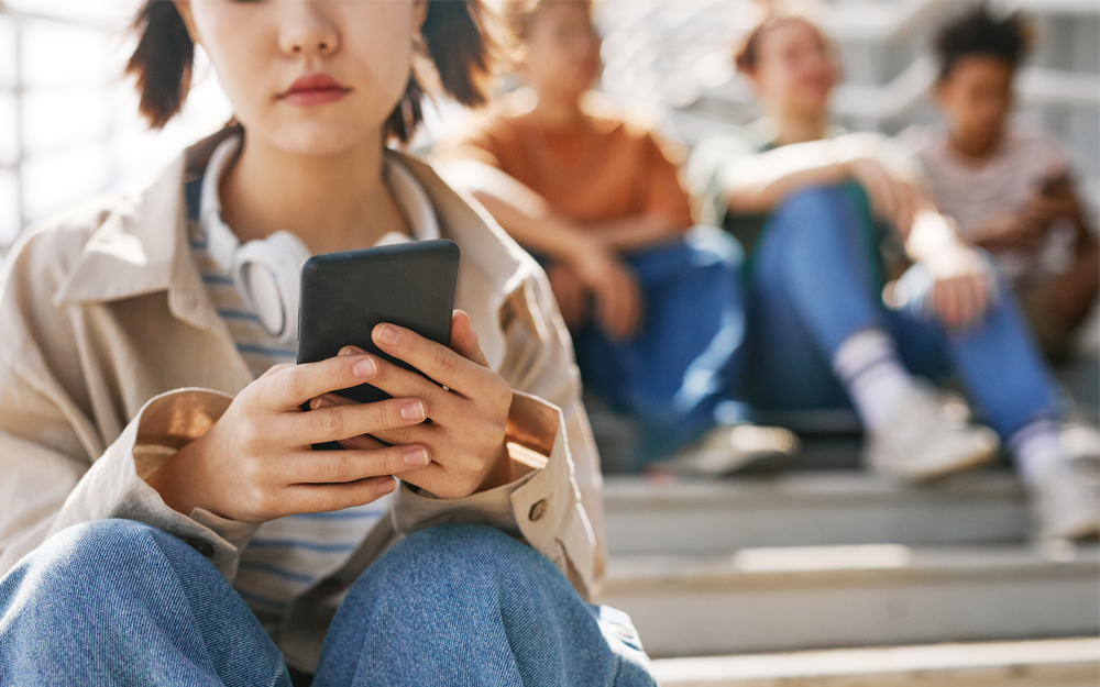 Isolated teen girl sending a text message