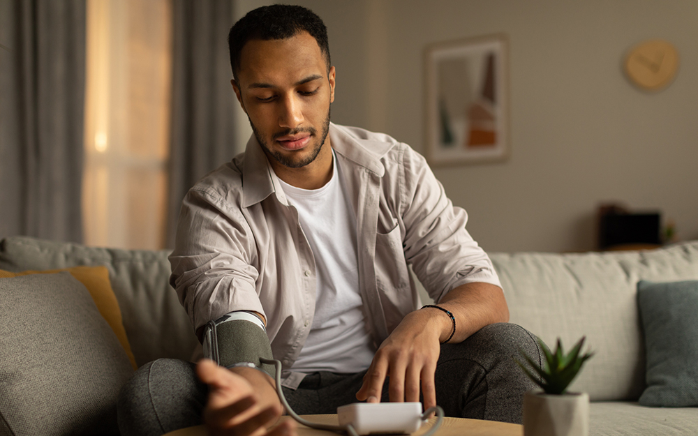 Young man taking blood pressure