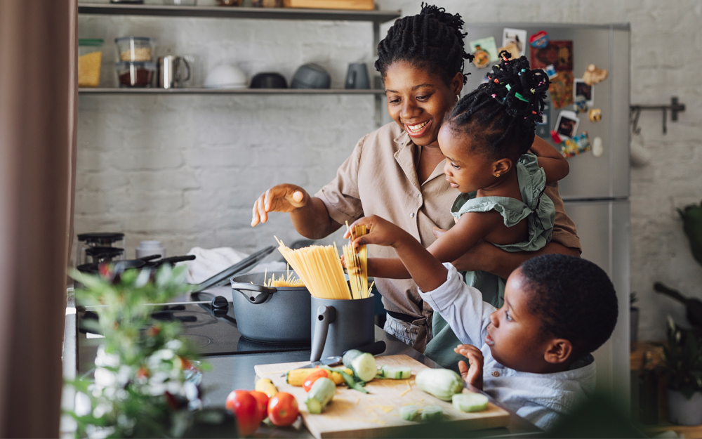 A family cooking spaghetti