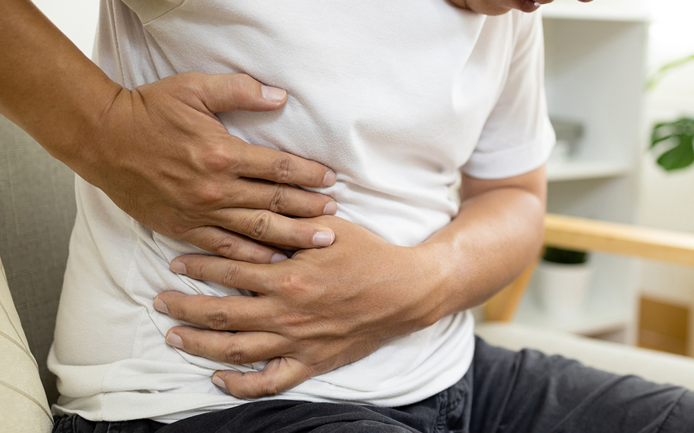 Asian male patient with abdominal pain on right side belly,painful in abdomen,irritable bowel,middle-aged man holds under the ribs,stomach ache,cirrhosis of the liver disease,liver cancer concept