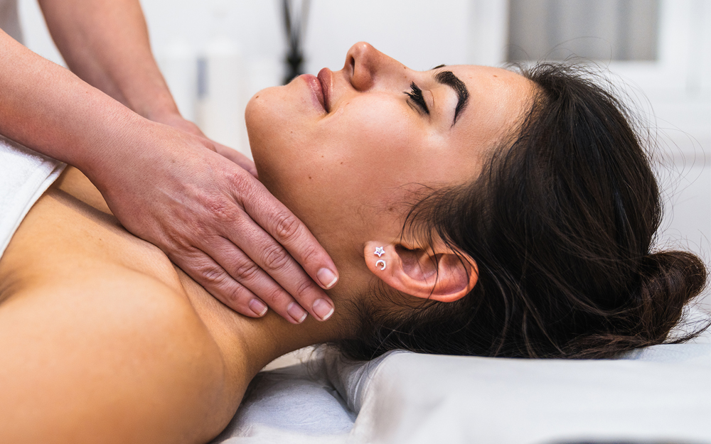 A woman receiving therapeutic neck lymphatic drainage