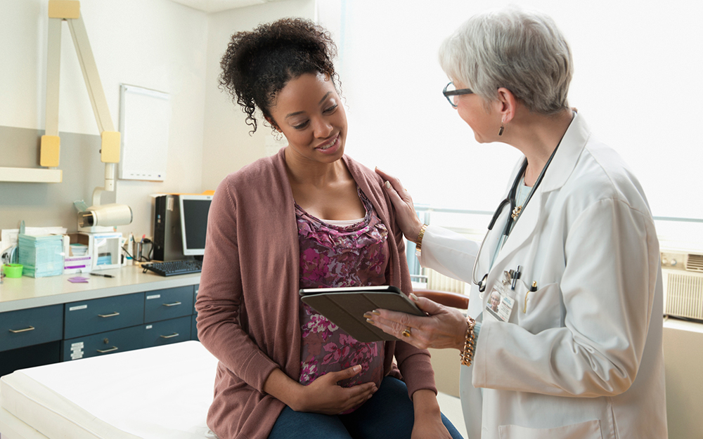 Pregnant woman with doctor