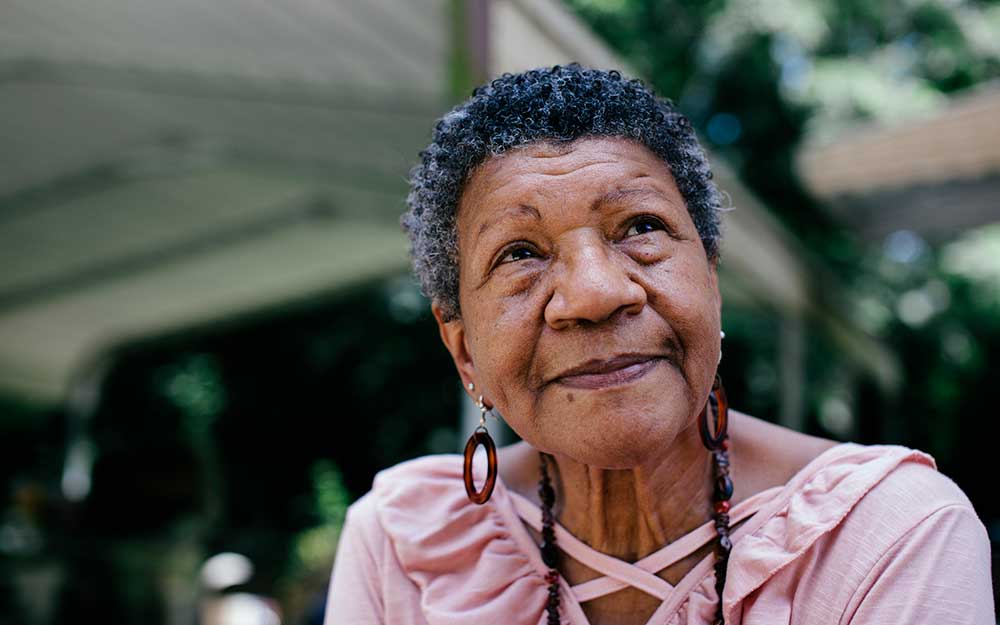 Close-up portrait of senior black woman looking thoughtful