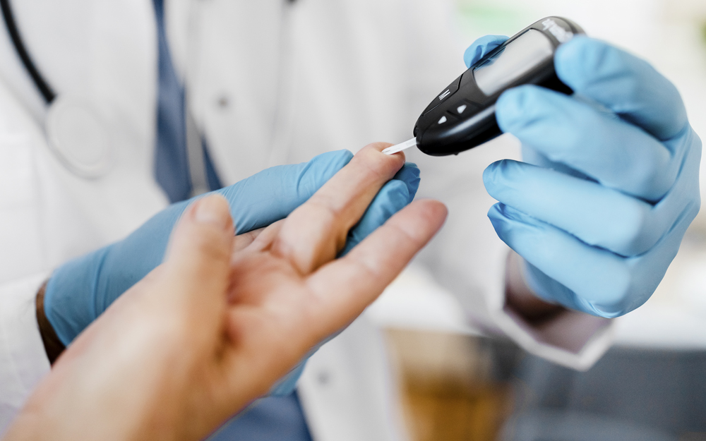 A doctor measuring a patients glucose