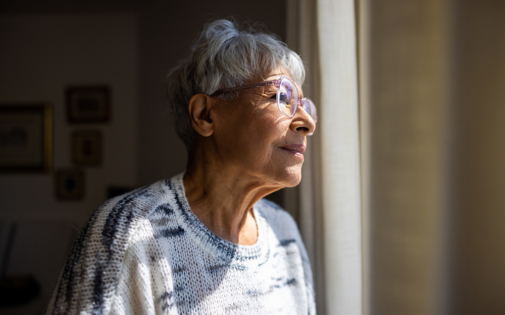 Elderly woman looking out the window