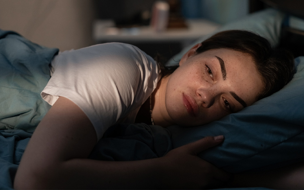 Young woman having trouble sleeping
