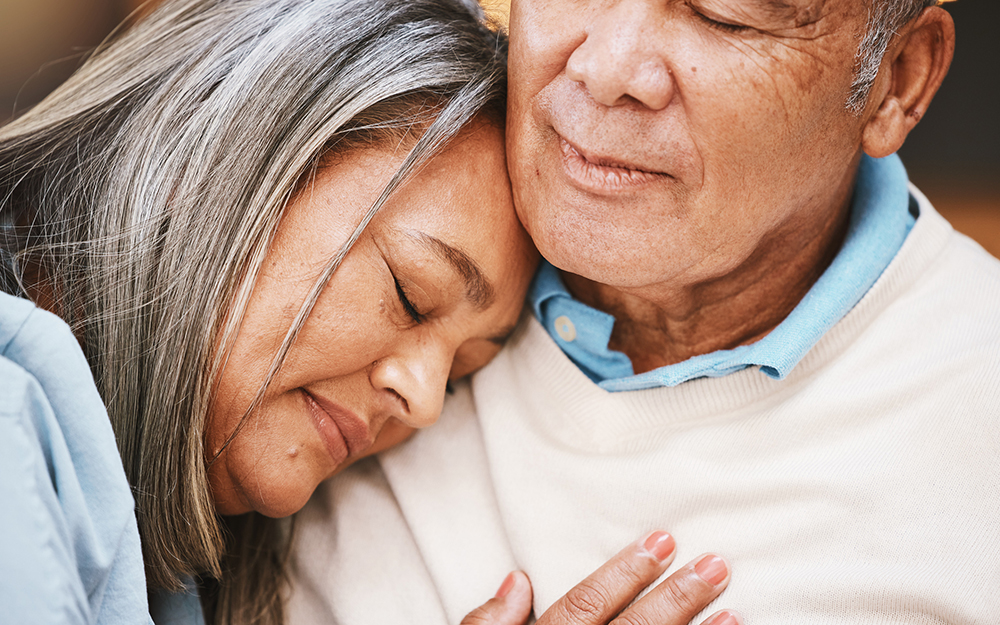Elderly woman leaning her head on her partner's shoulder