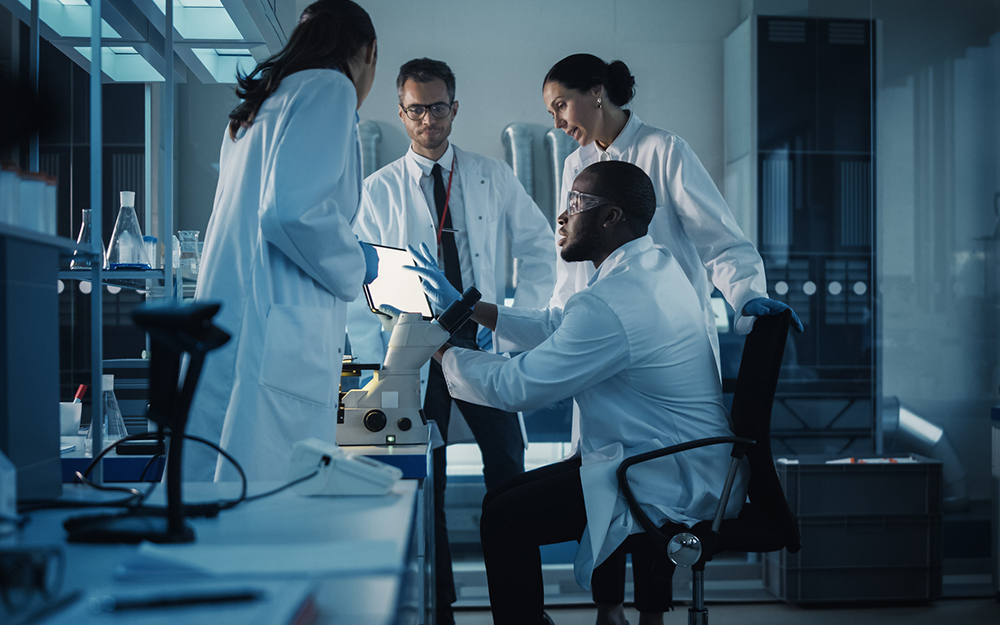 Diverse multi-ethnic scientists having a meeting in a lab.