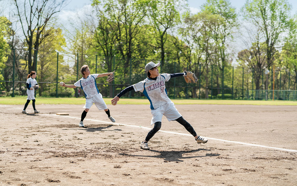 Three baseball players throwing baseballs.