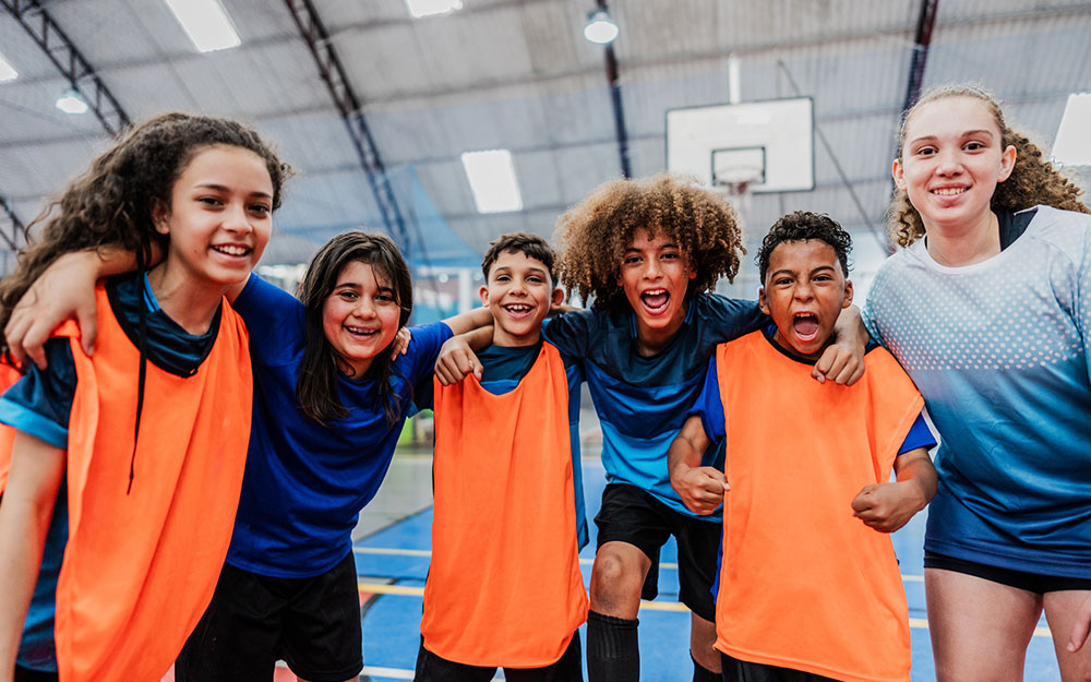 A kids basketball team at a basketball court.