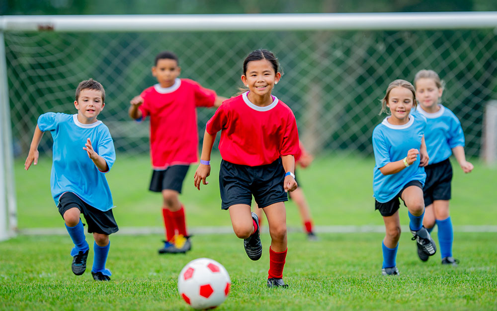 Group of children playinig soccer.