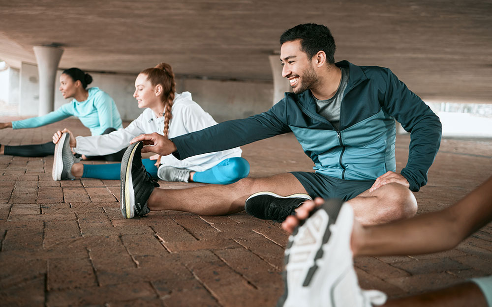 Group of friends stretching together before a workout.