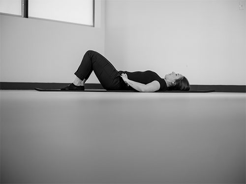 Woman lying on her back.