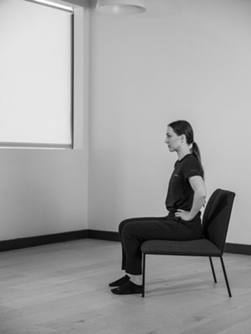 Woman sitting on chair.