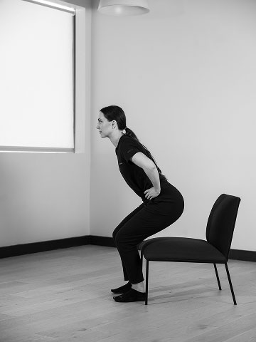 Woman getting up from chair.