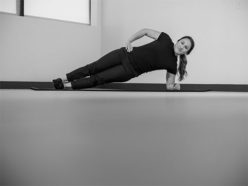 Woman performing a side plank.