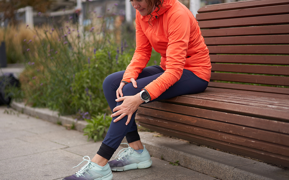 Woman holding knee after a run.