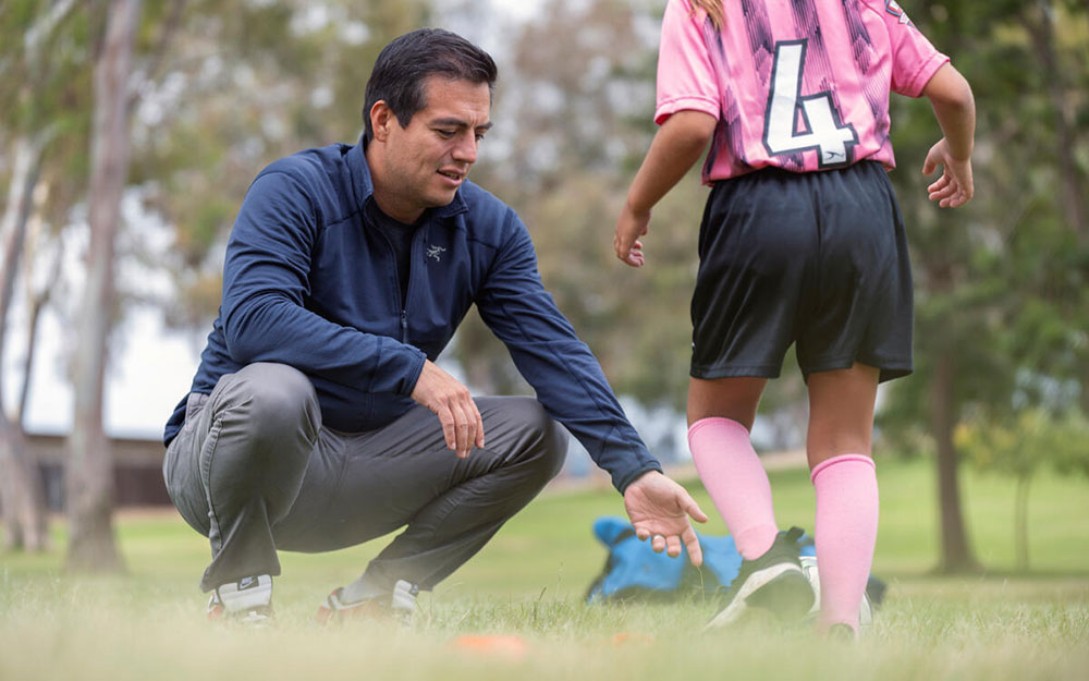 Carlos Uquillas, MD, assesses a player’s movements.