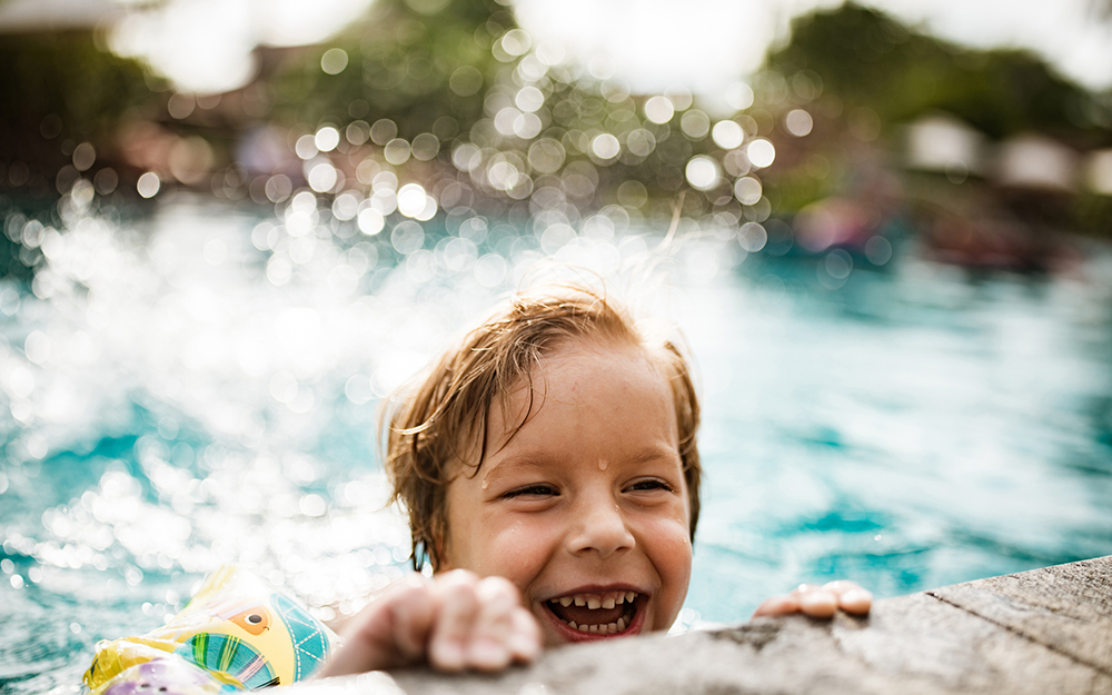 Boy swimming in a pool.