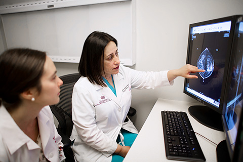 Two medical workers looking over image