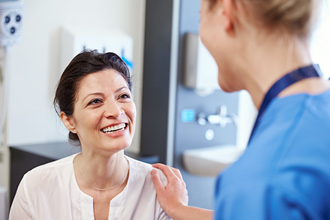 Nurse with hand on a patient shoulder