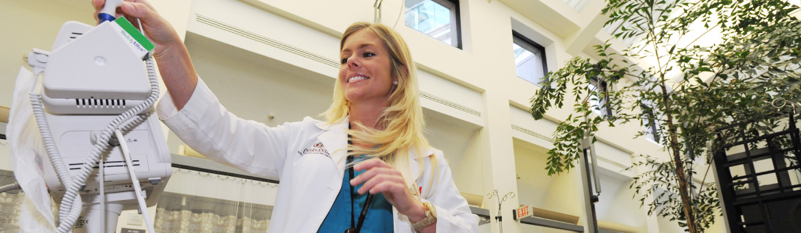 Doctor in lab working with machine (1170x340 image size)