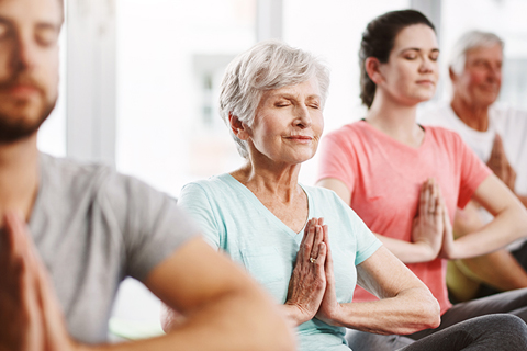 A couple of people doing yoga