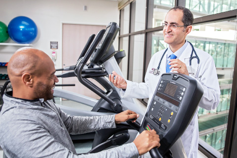Man working out as doctor watches (Cancer)
