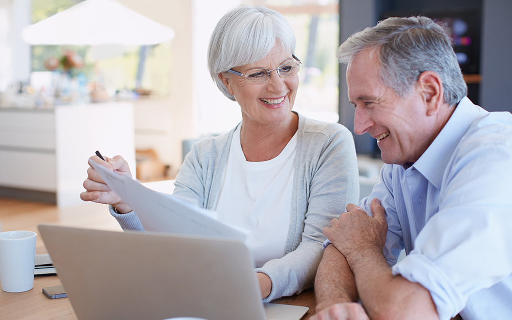 Elderly couple reviewing paperwork