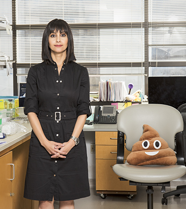 Suzanne Devkota, PhD, with a "poop pillow."