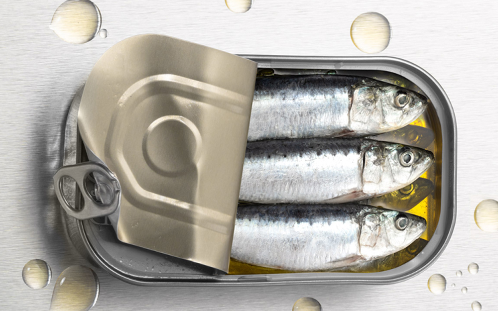 An open can of sardines with nutrient rich fish oil.