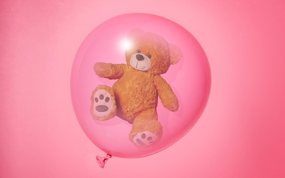 An illustration of a teddy bear in a pink balloon depicting how a placenta functions.