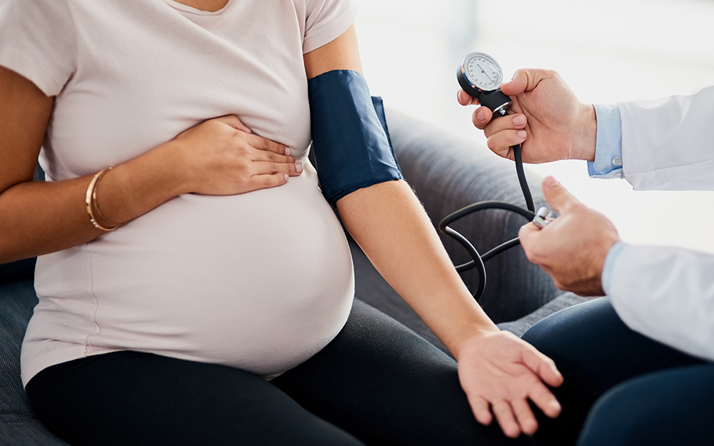 Pregnant woman having her blood pressure taken.