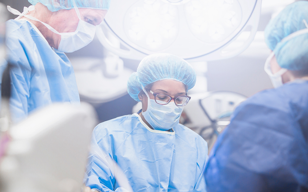 Three surgeons in the operating room.
