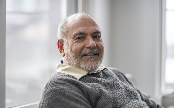 Older man sitting on a couch.