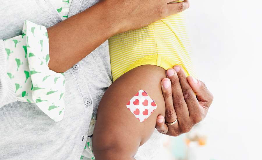 Baby with a bandaid on leg