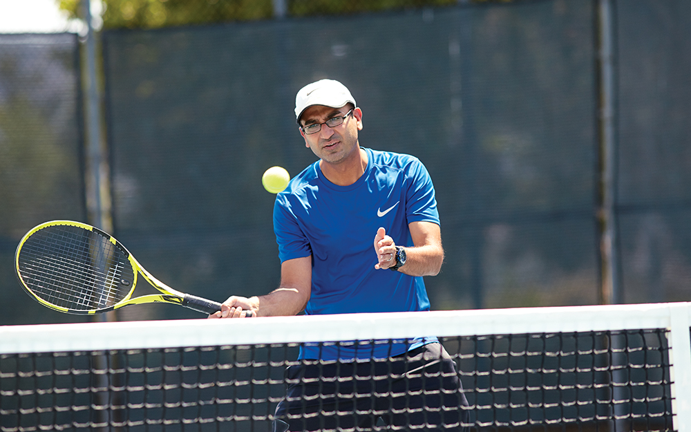 Mehul A. Thakkar, MD, playing tennis.