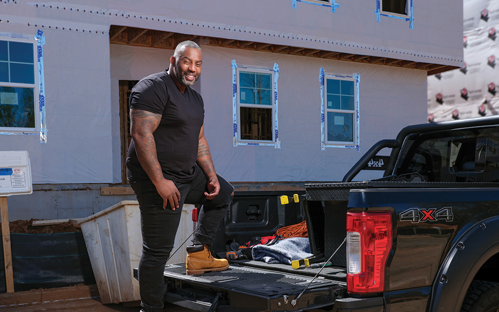 John Wharton outside stepping into his truck.