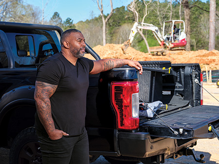 John Wharton next to his truck.