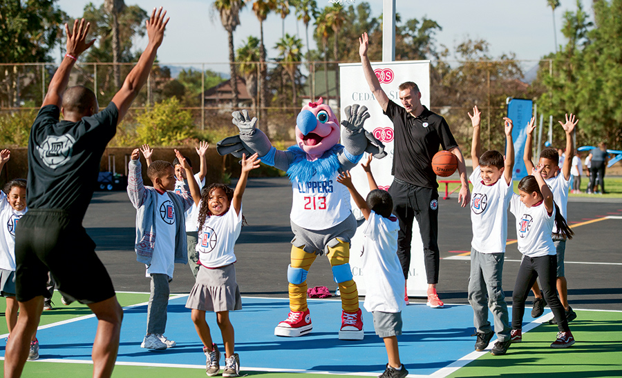 Kids playing basketball with the Clippers