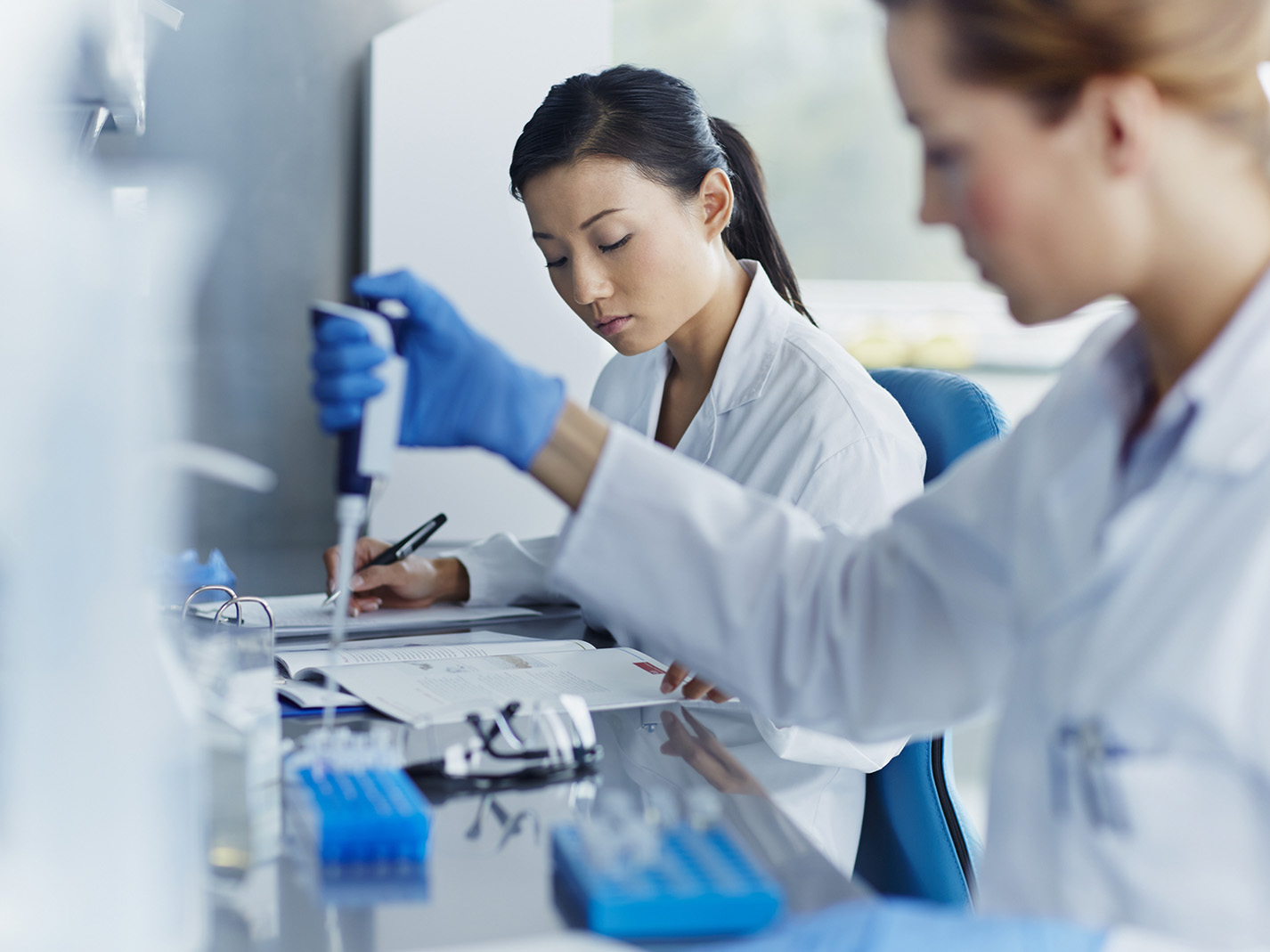 Female scientists working in modern biotechnology laboratory