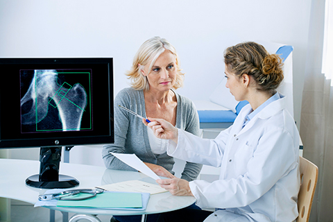 Patient with doctor looking at X-ray