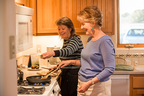 Beth Johnson cooks dinner with partner Char Schnepf.