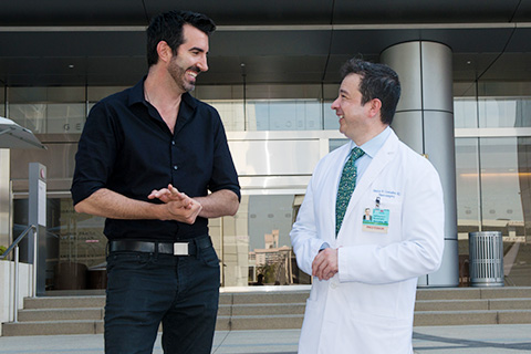 gonzales gabrielgoldberg speaking with doctor in front of building